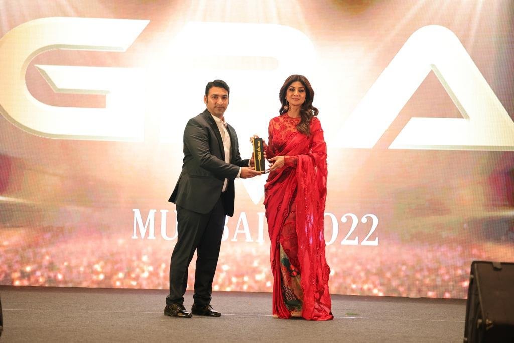 Award ceremony image showing a medical professional receiving recognition at a prestigious healthcare awards event in Mumbai.